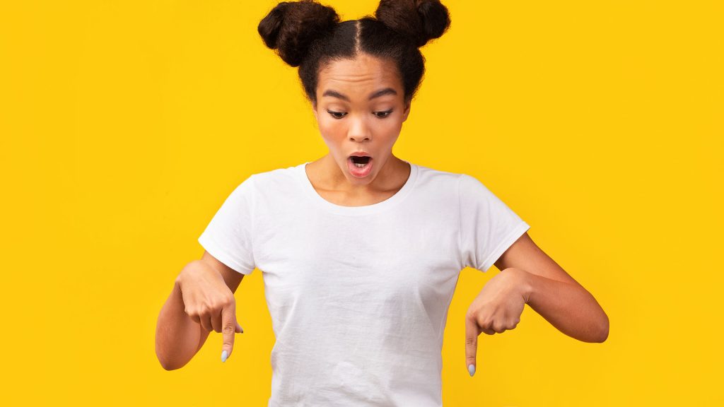 adobe stock image woman pointing down pigtails