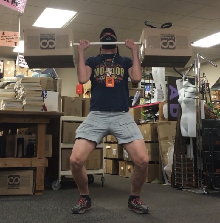 bookstore employee weight lifting book boxes