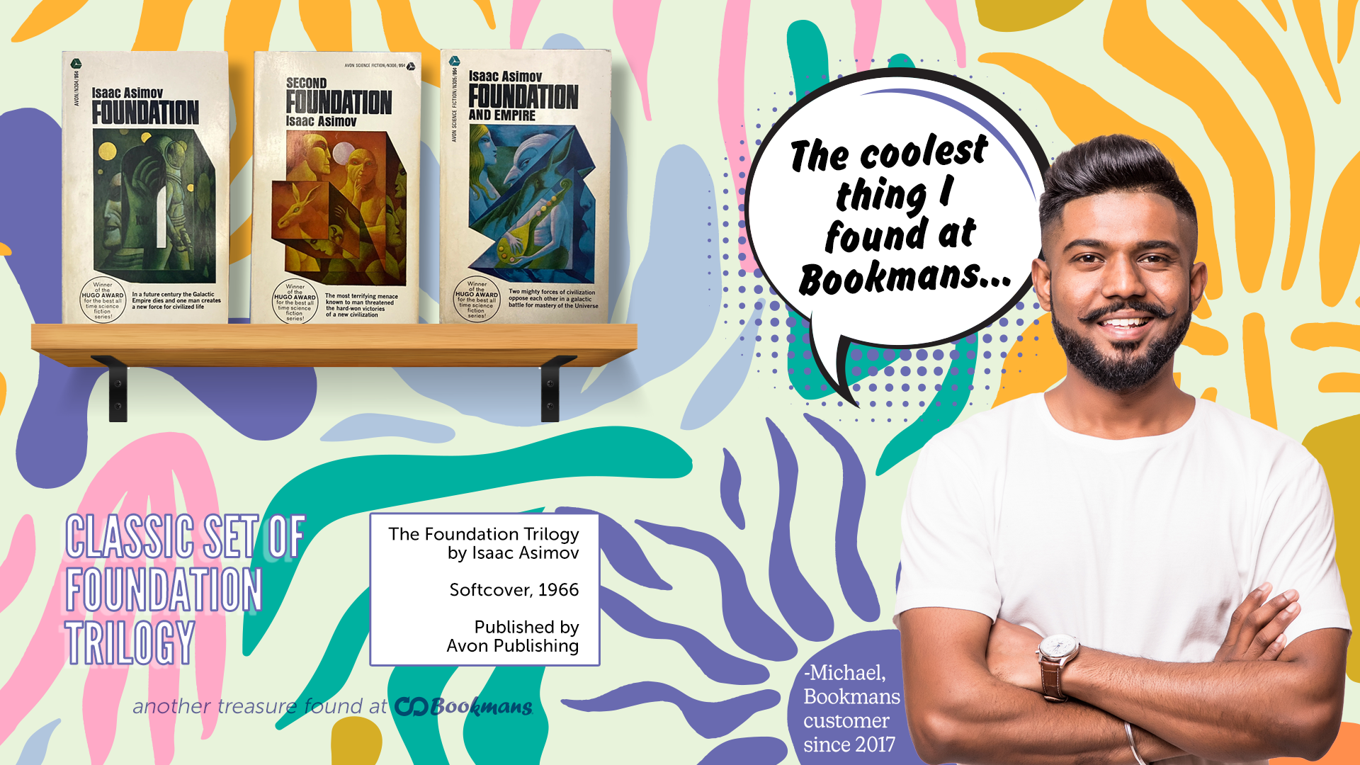 Bookmans monthly posters featuring a shelf of Isaac Asimov books from the 1966 Foundation Series release against a colorful shapes backdrop. A young Asian man in a white t-shirt with his arms folded stands in front of a quote bubble that reads The Coolest thing I Found at Bookmans... 