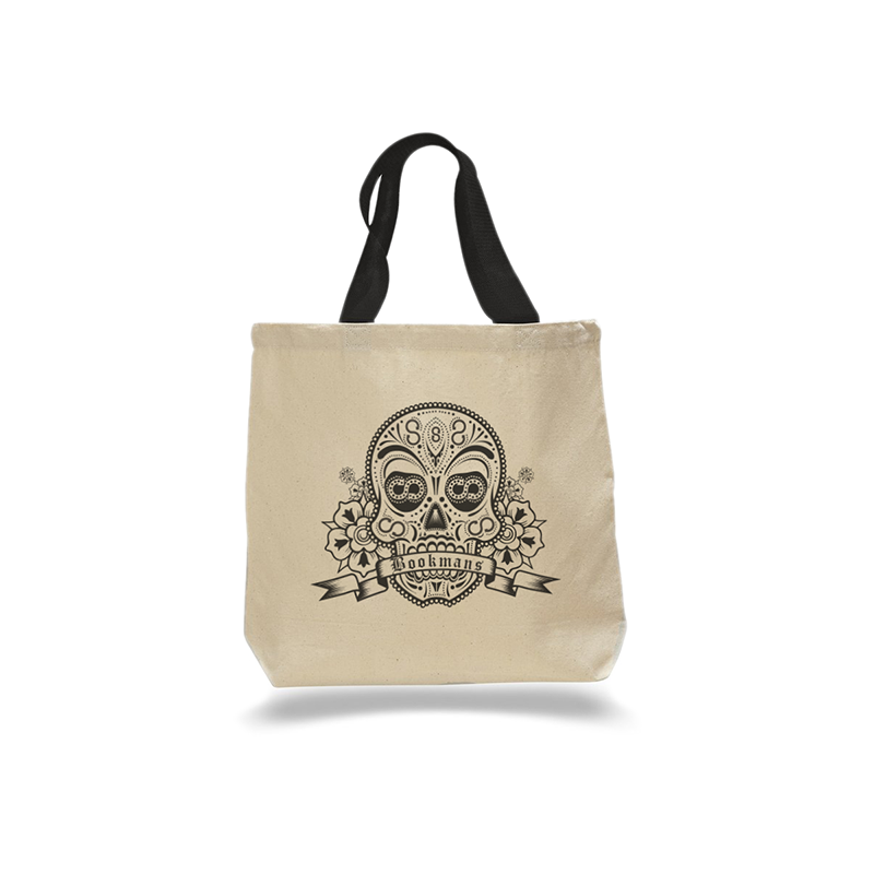 Bookmans sugar skull canvas tote bag featuring a black sugar skull bookmans logo on a cream tote bag with black handles. Front view.