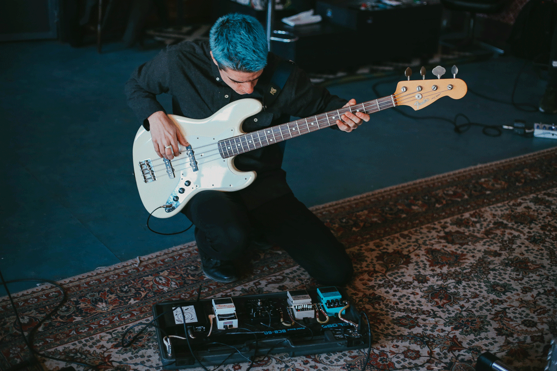 blue-haired young man with guitar