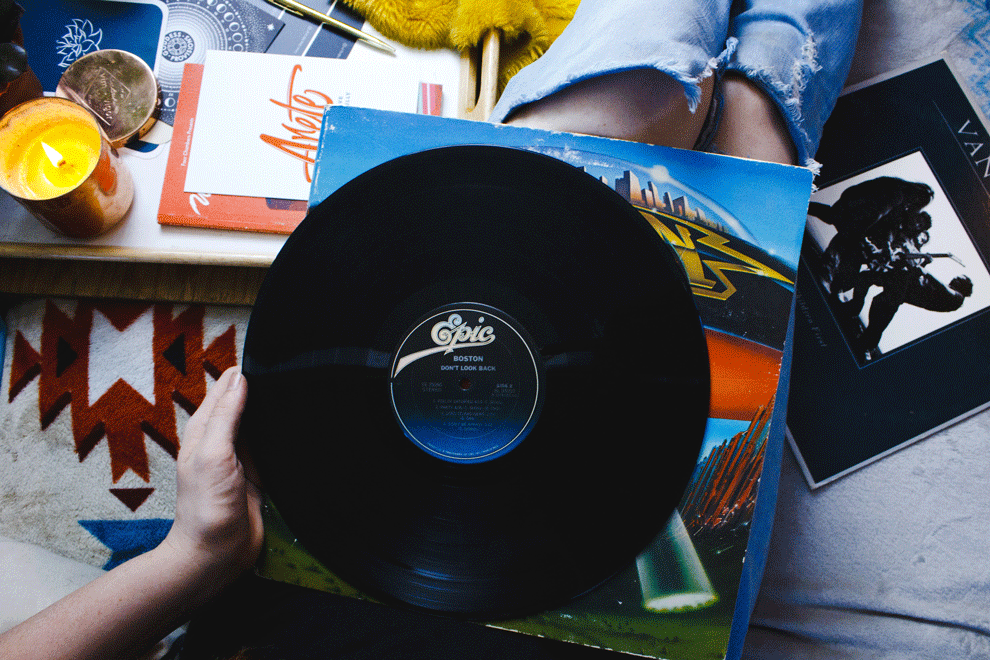 woman holding vinyl record