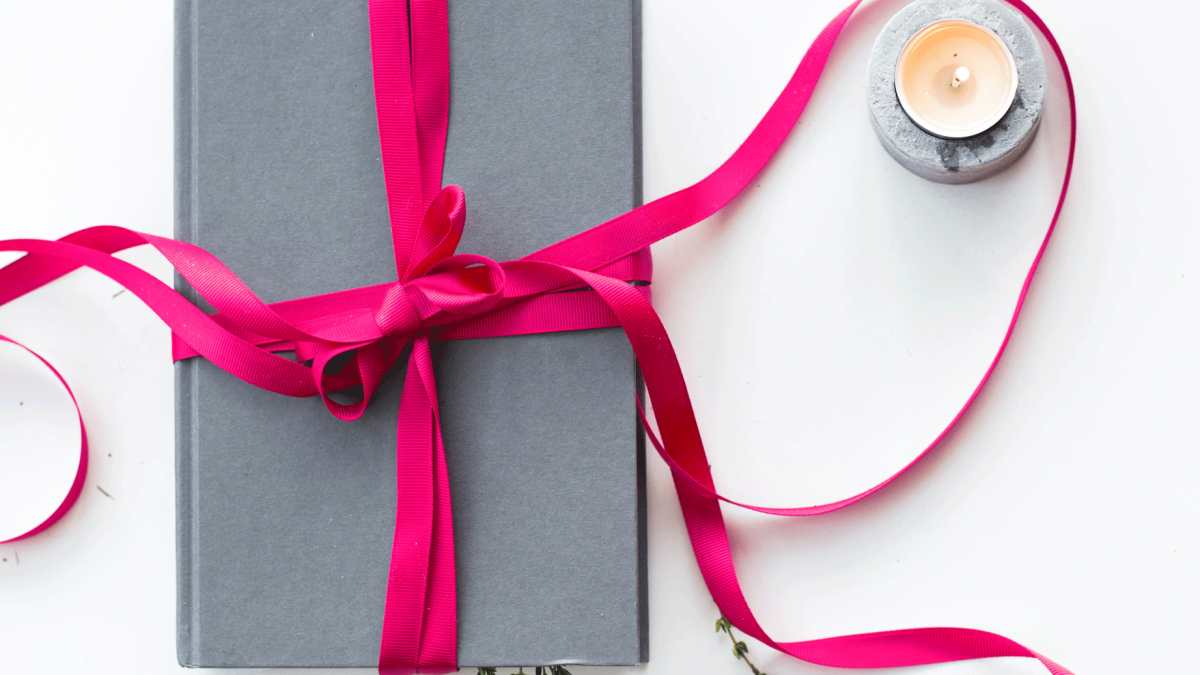 book wrapped in bright pink ribbon