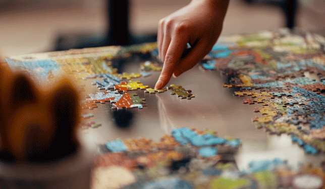 puzzle being put together on table